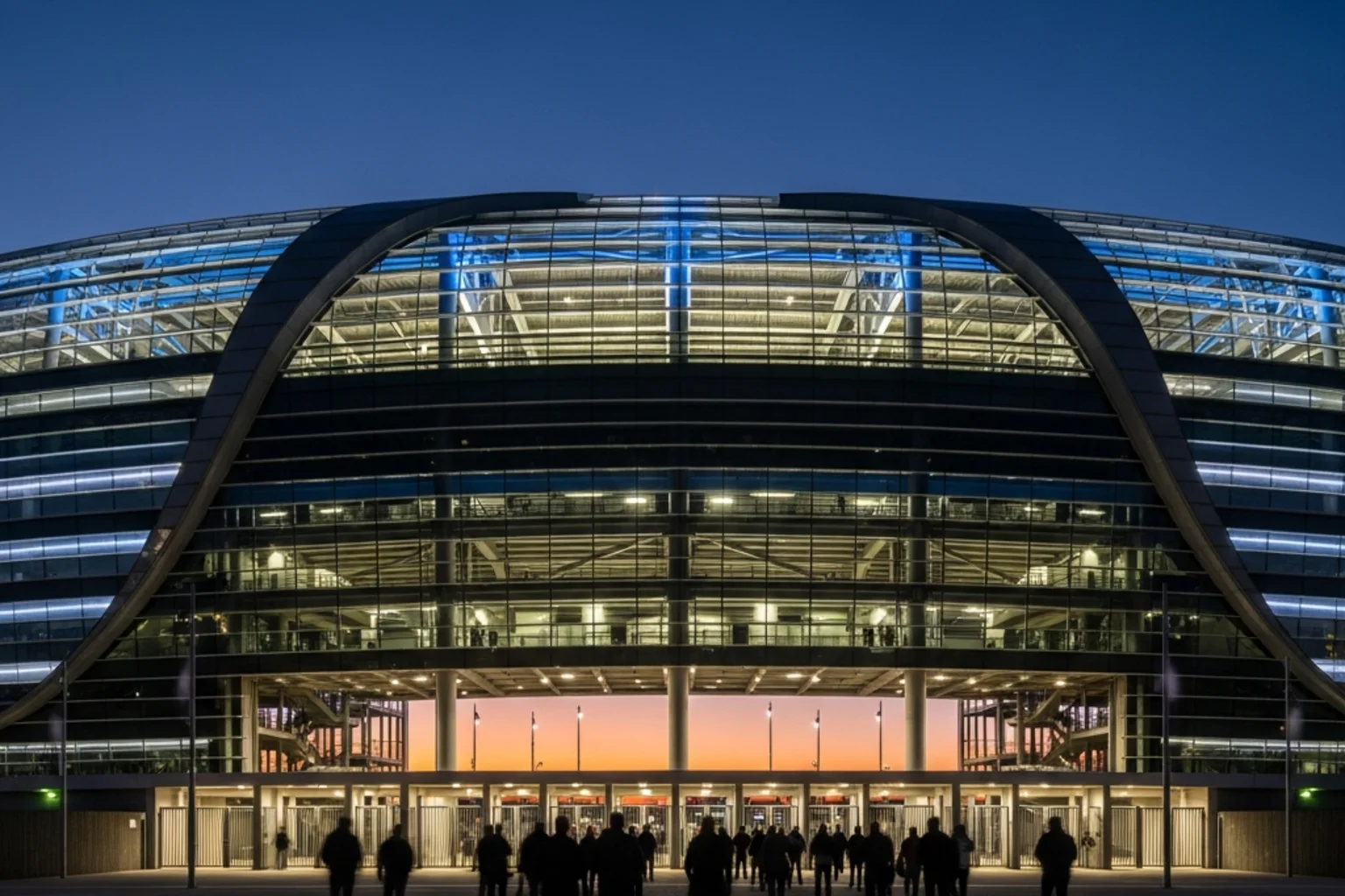 Façade extérieure d'un grand stade moderne nord-américain illuminé en soirée avant un match de Coupe du Monde